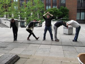 team using their bodies to spell the word TEAM