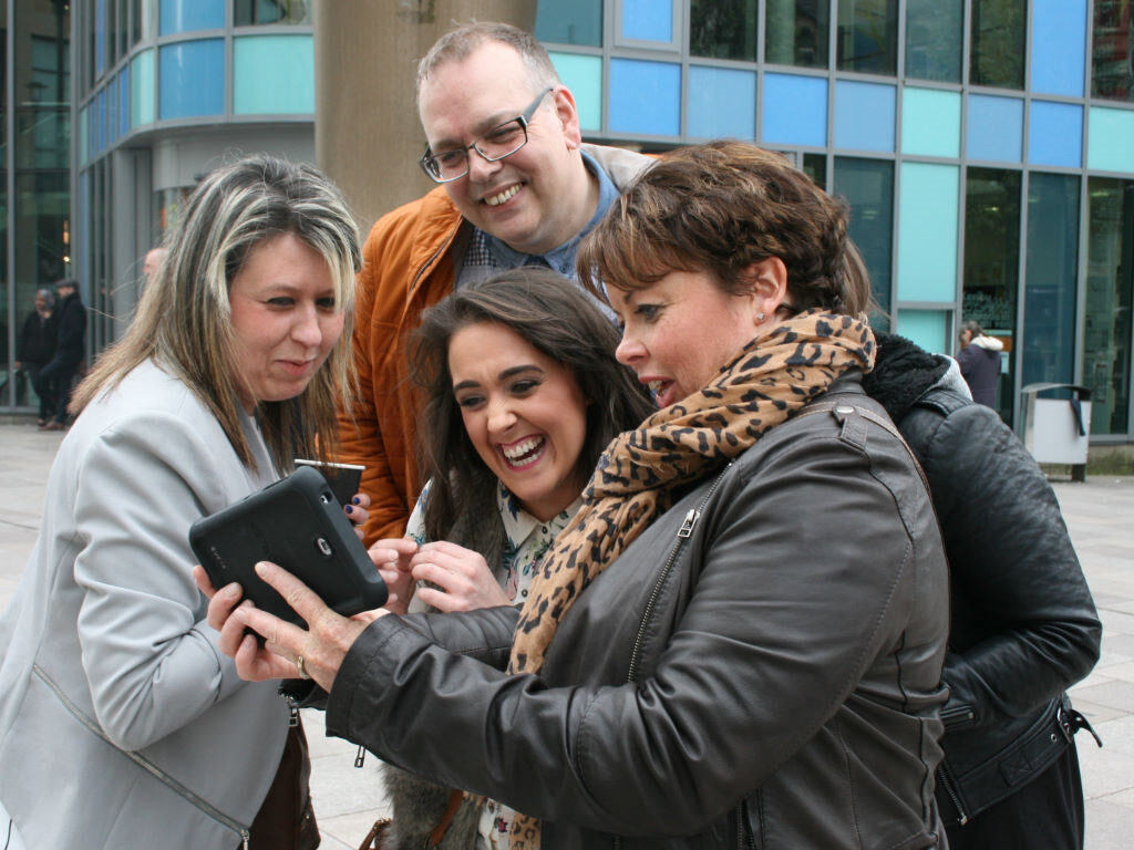 team on treasure hunt looking at tablet